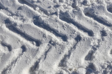 Traces of car wheels, tracks in the snow. Pure white snow.