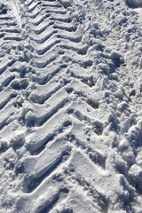 Fototapeta na wymiar Traces of car wheels, tracks in the snow. Pure white snow.
