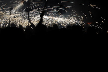 People playing with pyrotechnics in the street at a village. People having fun