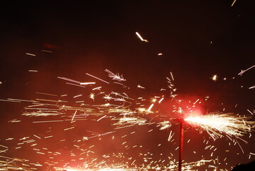People playing with pyrotechnics in the street at a village. People having fun