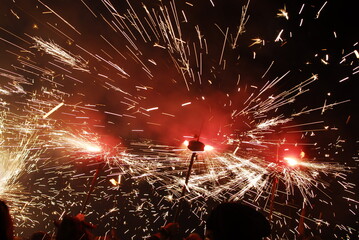 People playing with pyrotechnics in the street at a village. People having fun