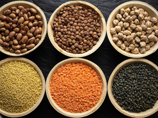 Dried, legume, leguminous plants, structure, assortment chickpea, kidney beans, pink coconut beans, green lenses, beluga lenses, millet, coral lenses, blond lenses, background. Flat lay, top view.