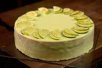 Lime cheesecake on the old wooden board, close up