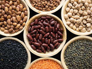 Dried, legume, leguminous plants, structure, assortment chickpea, kidney beans, pink coconut beans, green lenses, beluga lenses, millet, coral lenses, blond lenses, background. Flat lay, top view.