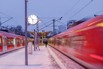 Night outdoor view on platform railway station, railway track covered by snow, and motion of...