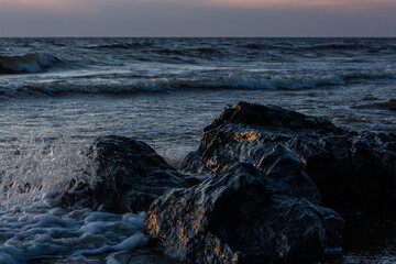 rocks by the sea at sunset