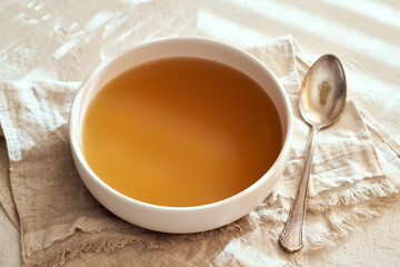 Beef bone broth in a bowl on a table