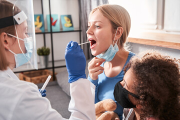 Doctor performs coronavirus swab on caucasian woman