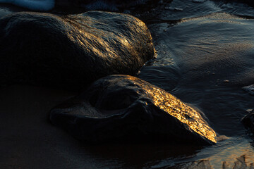 stones at sea at sunset and in the long exposition