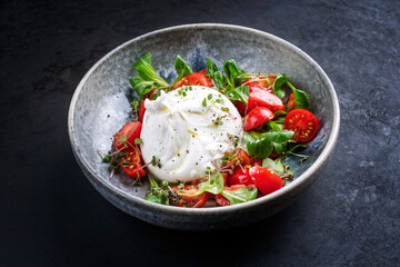 Modern style Italian apulia burrata cow milk cheese made from mozzarella and cream served with...