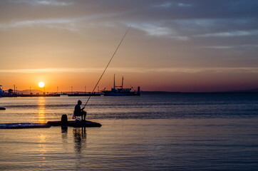 Pefkochori, Greece - May 30, 2016: Fishermen engaged in recreational fishing, on the shores of Pefkochori in Greece