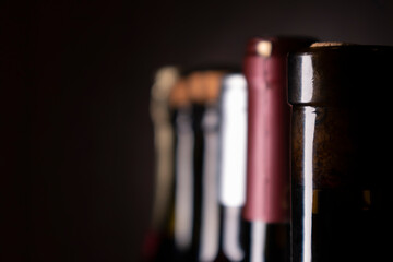 Bottles of red wine and sparkling wine on a dark background. Selective focus
