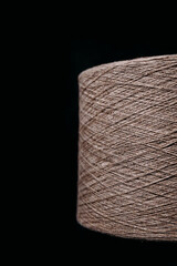 a skein of thick thread on a dark background.