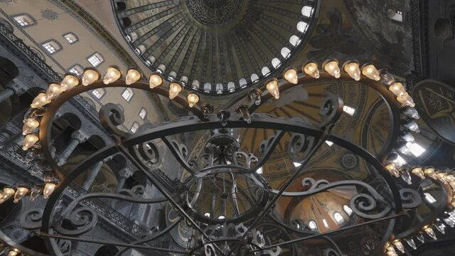 Interior of pompous palace with beautiful chandelier. Action. Bottom view of magnificent castle ceiling, concept of architecture. 