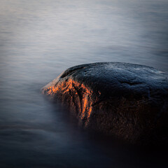 stones at sea at sunset and in the long exposition
