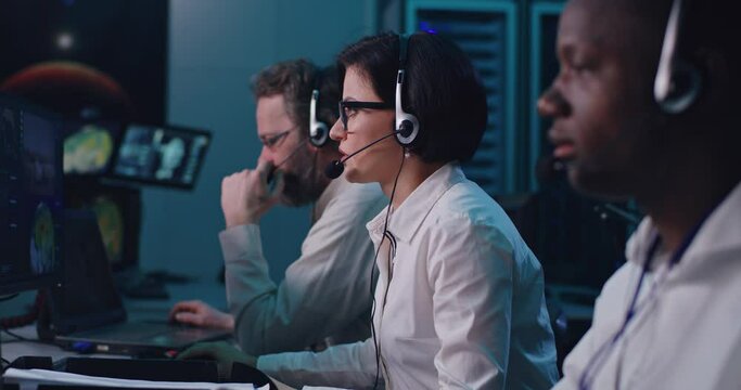 Diverse team of dispatchers working in mission control center
