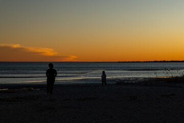 Fototapeta premium Walking at sunset near the ocean.