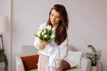 girl with a bouquet of tulips in the living room
