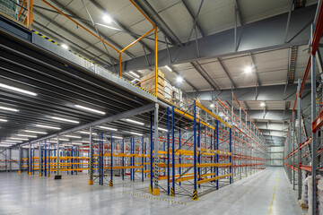 Interior of huge empty storehouse. Industrial warehouse racking.