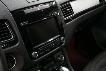 Fototapeta na wymiar Multimedia screen in modern car. Interior detail.