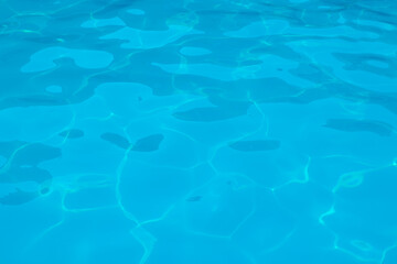 Fototapeta na wymiar Perfect texture of clear blue water in the swimming pool, ocean or sea. Top view. copy space. shimmering water. Abstract background