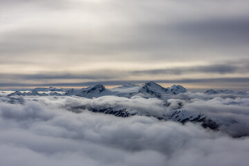 Fototapeta na wymiar Whistler, British Columbia, Canada. Beautiful View of the Canadian Snow Covered Mountain Landscape during a cloudy and vibrant winter day.