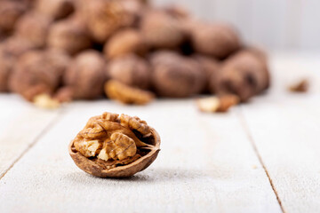 walnuts spilled from the basket on the white wooden