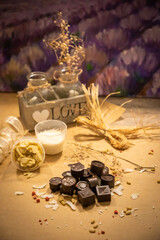 Handmade candies with fresh and dried fruits on light paper background in rustic style