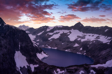 Fototapeta na wymiar Striking aerial landscape view of Silver Lake surrounded by rugged mountain peaks. Colorful Sunset Sky Art Render. Located Northeast of Seattle, Washington, USA.