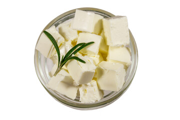 Feta cheese cubes with rosemary in glass bowl isolated on white background