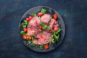 Modern style traditional Commonwealth Sunday roast with sliced cold cuts roast beef served with...