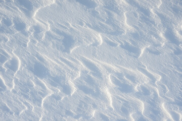 Fresh clean white snow background texture. Winter background with frozen snowflakes and snow mounds. Snow lumps. Seasonal landscape details. Cold weather.