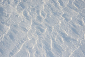 Fresh clean white snow background texture. Winter background with frozen snowflakes and snow mounds. Snow lumps. Seasonal landscape details. Cold weather.
