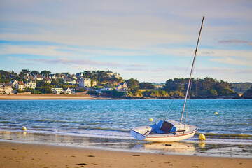 Yacht anchored on sand beach in Erquy, Brittany, France