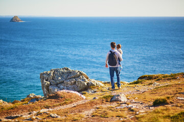 Man and toddler girl enjoying scenic view of Crozon peninsula in Finistere, Brittany, France