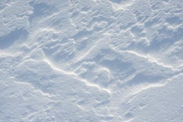 Fresh clean white snow background texture. Winter background with frozen snowflakes and snow mounds. Snow lumps. Seasonal landscape details. Cold weather.
