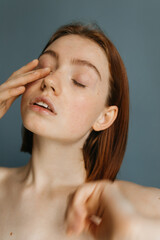 Woman standing with eyes closed in front of the camera