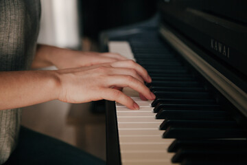 Fototapeta na wymiar Playing piano Caucasian Person's hands playing on the piano. Hobbies concept.