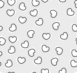 Endless seamless monochrome pattern of hearts of different directions. Black and white vector hearts. Wallpaper for wrapping paper.
