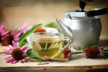 Soft focus. Echinacea tea set. Echinacea flowers, teapot, cup of tea.