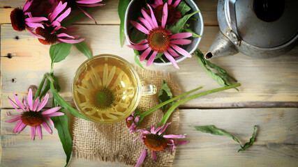 Soft focus. Echinacea tea set. Echinacea flowers, teapot, cup of tea.