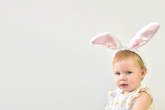 A little girl with bunny ears. Easter. Carnival. The Easter bunny. Banner with copy space