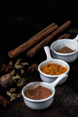 Set of spices on dark brown table. Top view. Copy space. 