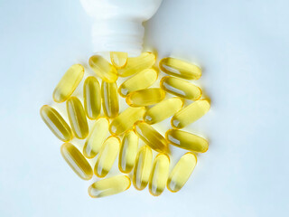 Omega-3 capsules with the bottle on white background. Polyunsaturated fatty acids. The concept of a healthy lifestyle.
