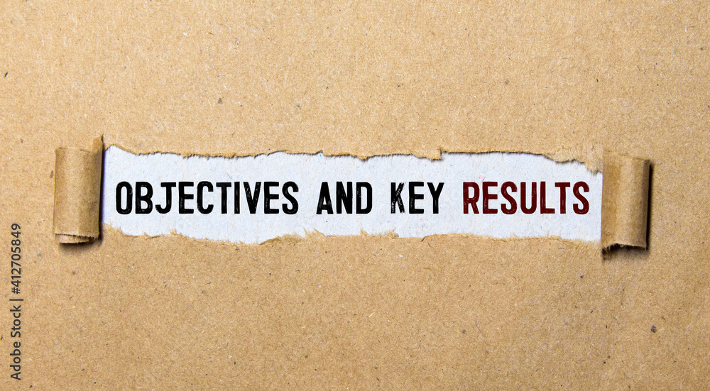 Poster objective key results text in the office notebook. view from above.