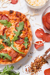 pepperoni pizza with mozzarella cheese and homemade dough on a marble background