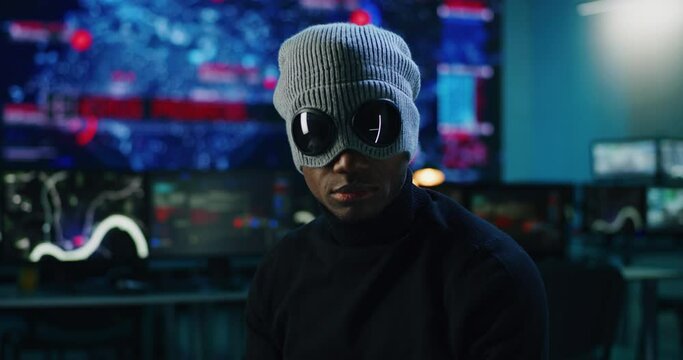 Black hacker looking at camera