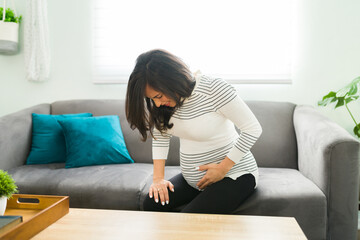 Stressed pregnant woman alone with contractions