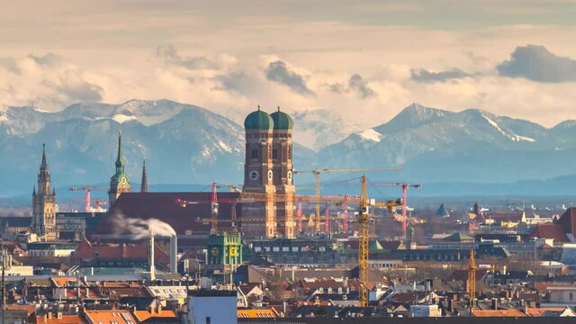 Munich cityscape time lapse at winter in background pre alps mountains covered with snow, munich skyline.