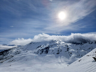 Snowy peaks and mountains in a sunny day